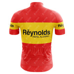 The 1980s red Reynolds Retro Short Sleeve Cycling Set features a red and yellow design with Reynolds Papel Aluminio on the back, retro short sleeves, three rear pockets, and a subtle pattern reflecting classic 1980s style.