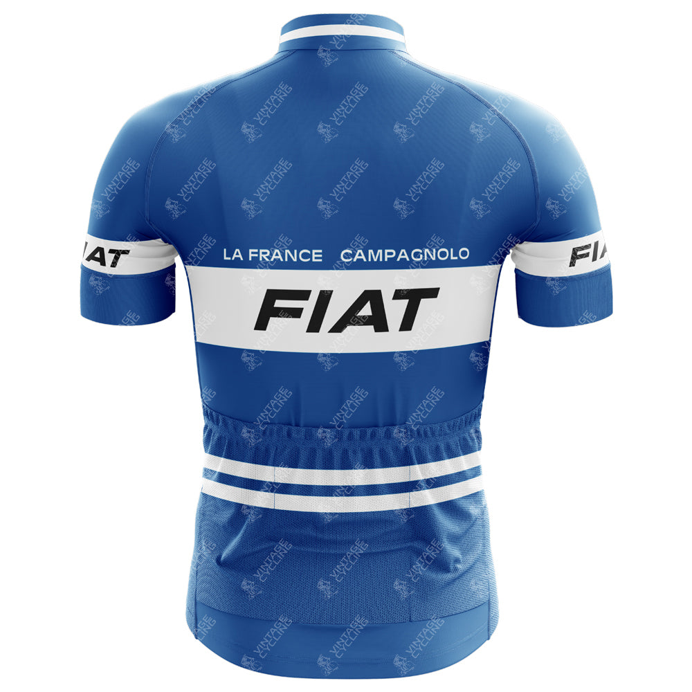 The FIAT France Cycling Jersey Eddy Merckx 1977 Retro boasts a lightweight blue polyester fabric with white stripes and logos, featuring FIAT, LA FRANCE, and CAMPAGNOLO on the back. It has short sleeves and subtle pattern details inspired by the iconic era.