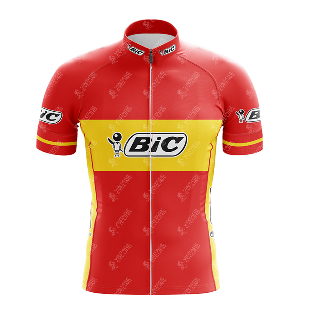 The BIC Red Retro Short Sleeve Cycling Set features a red and yellow jersey with a prominent BIC logo on the chest and upper sleeves, accented by white and black on the collar and sleeve edges, making it a standout piece.