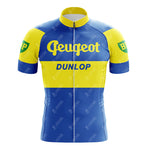 The Reynolds Aluminio Blue Retro Short Sleeve Cycling Set features blue and yellow stripes, Peugeot across the chest, DUNLOP below it, green BP logos on the sleeves, and a full front zipper for easy wear.