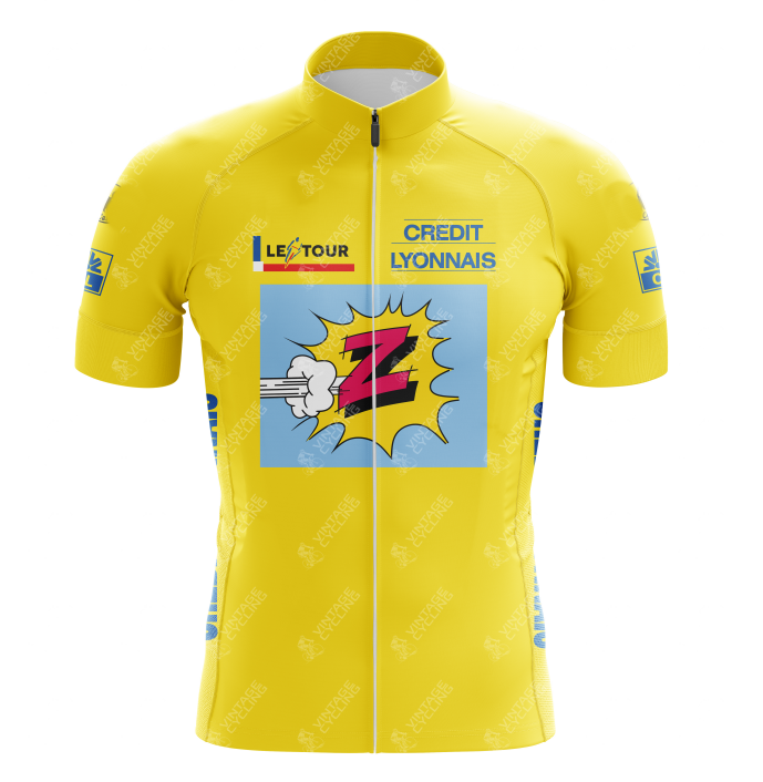 The Vetements Team Z Yellow Retro Cycling Jersey features a comic-style design with a stylized Z and white explosion graphic. It evokes retro charm with Le Tour and Credit Lyonnais logos, complemented by blue sponsor text on the sides and sleeves.