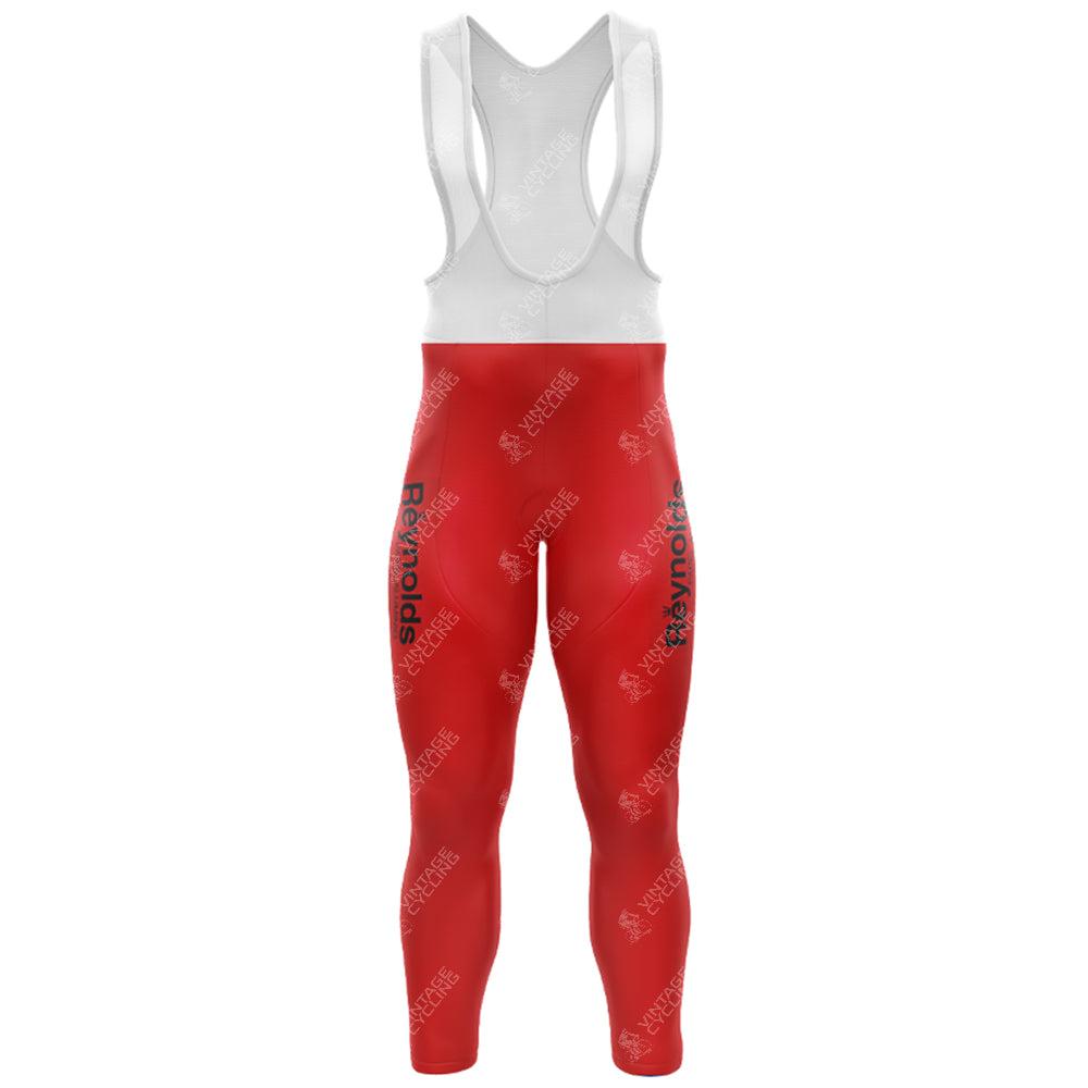 The 1980s Red Reynolds Retro Long Sleeve Cycling Set features red and white bib tights with Reynolds on the legs, a white upper part with shoulder straps, stretchy fitted material, and a gel seat pad for comfort during long rides.