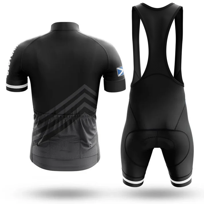 The Drinking Men Short Sleeve Cycling Set is a black set with a short-sleeve jersey and men's bib shorts, featuring three rear pockets, a Scottish flag on the sleeve, and subtle geometric patterns with white accents.