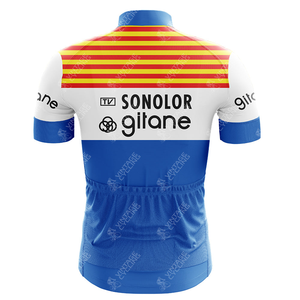 The Solo Superia Red Retro Short Sleeve Cycling Set features a back view of the jersey with red and yellow stripes on top, a logo-stamped white midsection, blue bottom, short sleeves, and lower back pockets. Mix and match different sized jerseys & shorts for an ideal fit!.