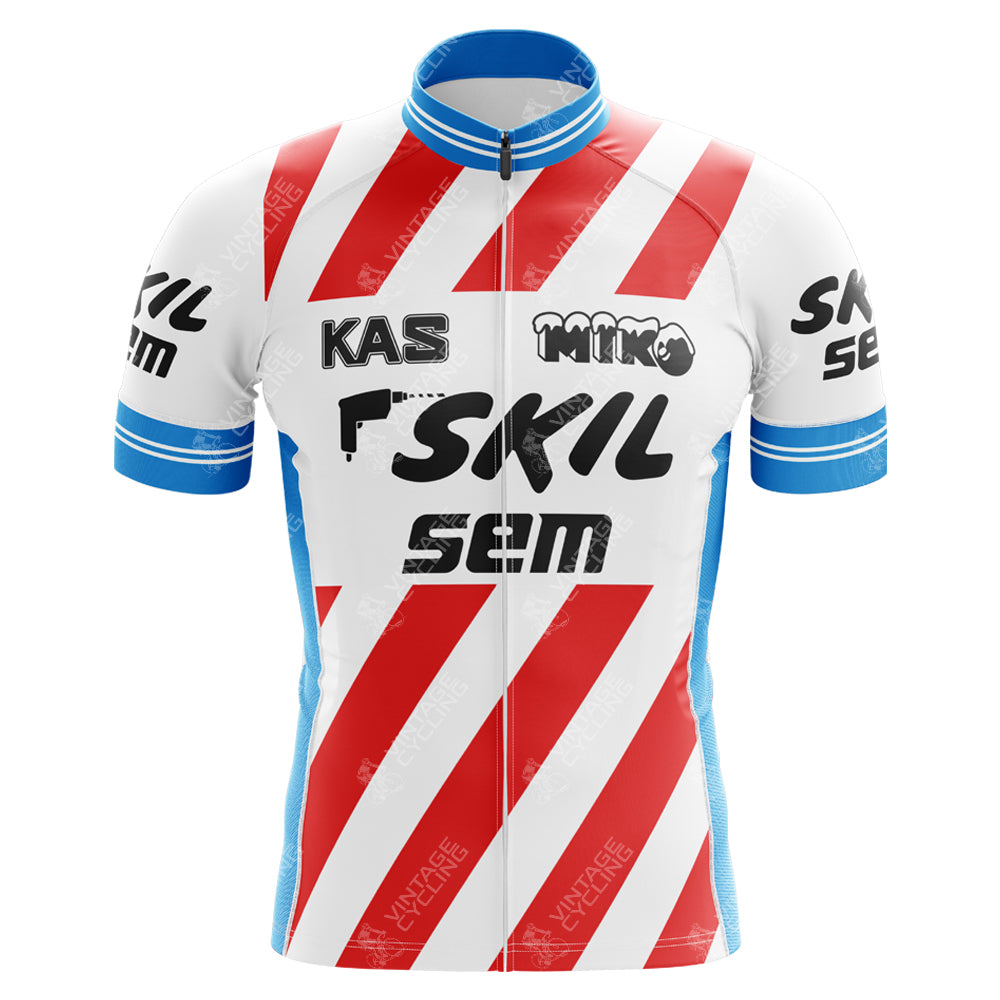 The KAS Skil Sem Retro Cycling Jersey displays diagonal red and white stripes with blue trim on the collar and sleeves. Crafted from lightweight polyester, it includes an internal silicone waist strip for a secure fit and features black and white brand logos on the front.