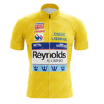 The Salvarani 1972 Retro Cycling Jersey is a yellow jersey with a front zipper and sponsor logos, inspired by classic cycling and the Tour de France.