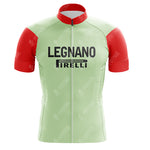 Against a white backdrop, the La Vie Claire Pink Retro cycling jersey features a green body and red short sleeves, with bold black Legnano and Pirelli text on the front. A center zipper completes this stylish piece from the classic cycling set.