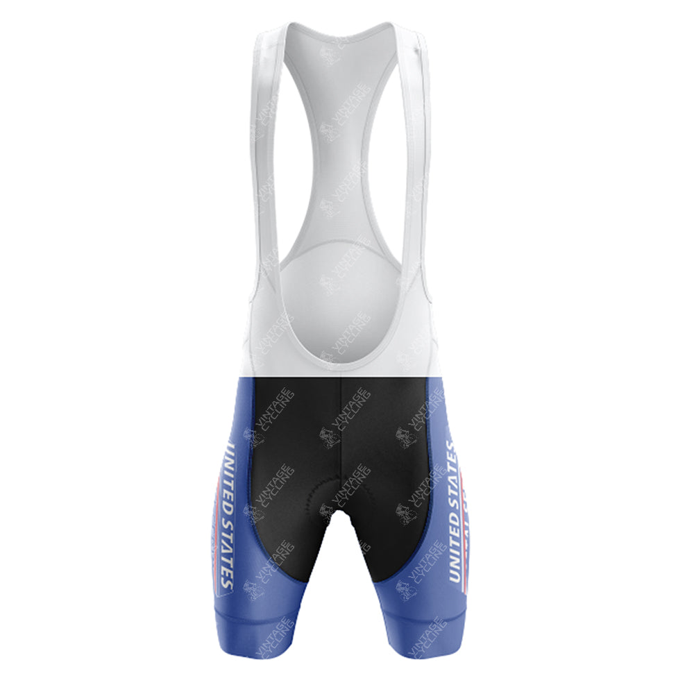 The EPEDEX Tricatel Retro Short Sleeve Cycling Set features a retro cycling jersey design with a white upper, black midsection, blue lower legs, and “UNITED STATES” in white on each leg for a classic US Postal Service-inspired look.