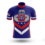 The Chief Short Sleeve Cycling Set is a blue retro jersey with red and white stripes, a large AIRBORNE emblem, wings, and AA logo on the chest. Sleeves feature the American flag and a round insignia—ideal for Airborne veterans.