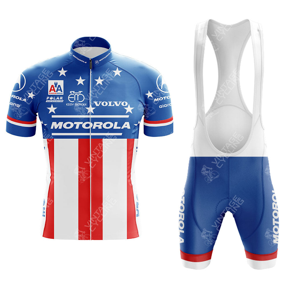 The MOTOROLA Retro Short Sleeve Cycling Set features a vintage blue, white, and red design with stars and stripes, plus classic logos like Motorola and Volvo. It includes bib shorts with a white top and blue bottoms accented by crisp white text.