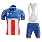 The MOTOROLA Retro Short Sleeve Cycling Set features a vintage blue, white, and red design with stars and stripes, plus classic logos like Motorola and Volvo. It includes bib shorts with a white top and blue bottoms accented by crisp white text.