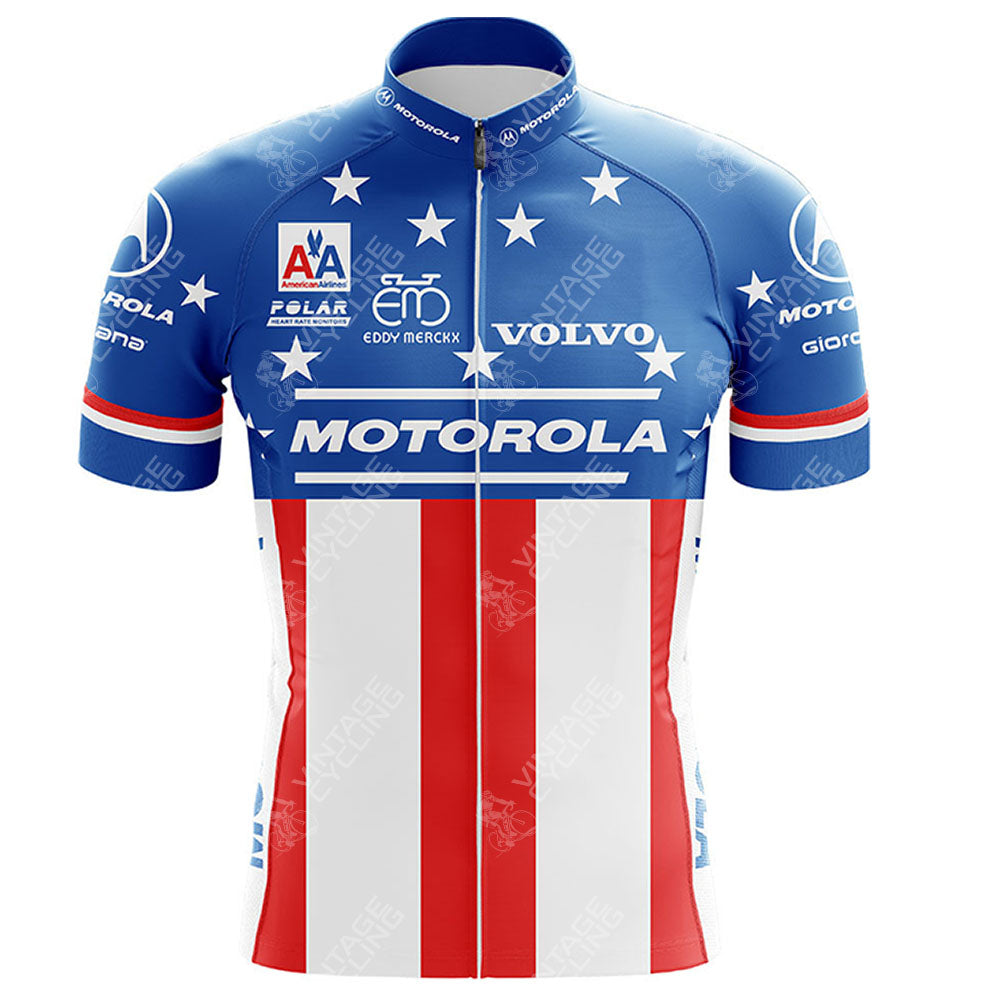 The MOTOROLA Retro Short Sleeve Cycling Set (Copy) features a blue top with white stars, a red and white striped bottom, brand logos like Motorola and Volvo, red and white striped sleeves, and a vertical zipper for a vintage cycling look.