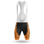The 11th Armored Cavalry Regiment Men Short Sleeve Cycling Set features bib shorts with a white upper, orange leg panels, black paw print patterns, and a black lower front. The design is shown on a white background and complements the Chicago flag cycling kit.