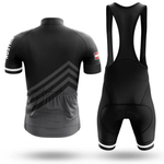 The Sloth Team Men Short Sleeve Cycling Set features a black jersey with geometric chevron patterns, three rear pockets, a small Chicago flag on the sleeve, and matching bib shorts with wide shoulder straps. Shown from the back.
