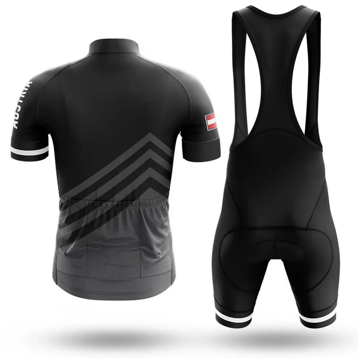 The Sloth Team Men Short Sleeve Cycling Set features a black jersey with geometric chevron patterns, three rear pockets, a small Chicago flag on the sleeve, and matching bib shorts with wide shoulder straps. Shown from the back.