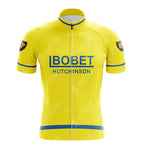 Vintage cycling enthusiasts will love the Maes-Pils Rokado Retro Short Sleeve Cycling Set. This yellow jersey features a full front zipper, adorned with blue BOBET and HUTCHINSON text across the chest and complemented by black and gold logos on the sleeves, capturing a classic retro vibe.