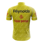 Rear view of the 1983s yellow Reynolds Retro Short Sleeve Cycling Set jersey showing black Reynolds text and a red Caixa Postal logo. It includes a zip-up back pocket and white stitching.