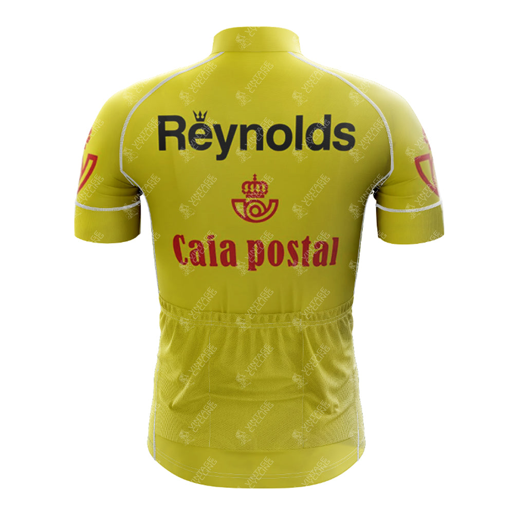 Rear view of the 1983s yellow Reynolds Retro Short Sleeve Cycling Set jersey showing black Reynolds text and a red Caixa Postal logo. It includes a zip-up back pocket and white stitching.