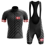 The Therapy Men Short Sleeve Cycling Set features diagonal grey stripes, Danish flags on the chest and sleeves, a moisture-wicking jersey, matching bib shorts, and solid black suspenders for comfort and style.
