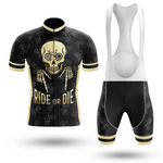 The California Men Short Sleeve Cycling Set features a black and gold performance jersey with a large skull, skeleton hands, RIDE OR DIE text, bike patterns, and matching black bib shorts with subtle bike prints.