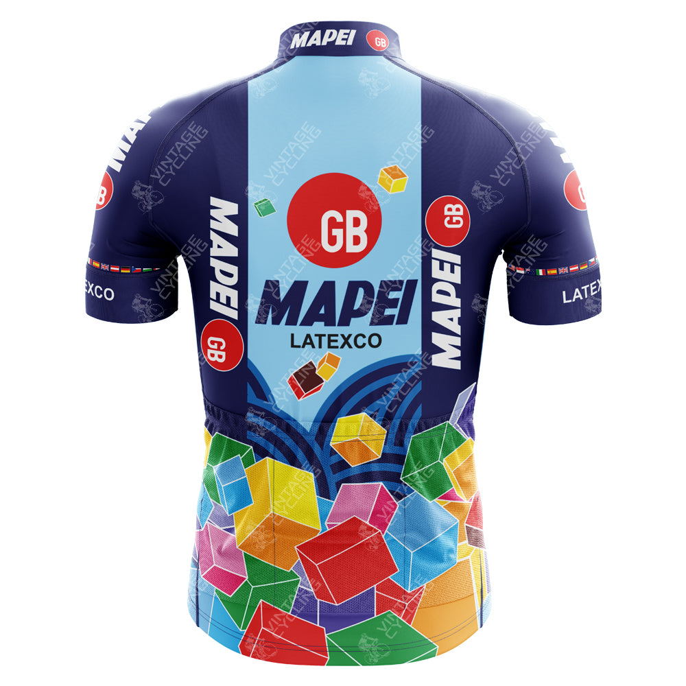 The Mapei GB Colnago Retro Cycling Jersey features a colorful back design with geometric shapes. GB and MAPEI stand out on a blue backdrop, accented by vibrant cubes at the bottom, capturing the essence of a classic cycling team jersey.