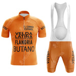 The Gatorade Chateau dAx Retro Short Sleeve Cycling Set includes an orange jersey and bib shorts adorned with black VELDA and BUTANO logos on the front, sleeves, and legs. Check the size guide for a perfect fit.
