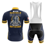 The U.S. Navy V3 Men Short Sleeve Cycling Set features a navy and yellow jersey with “Never underestimate an old man who defended your country, Navy veteran” and anchor, eagle, flag graphic. Includes black and white bib shorts.