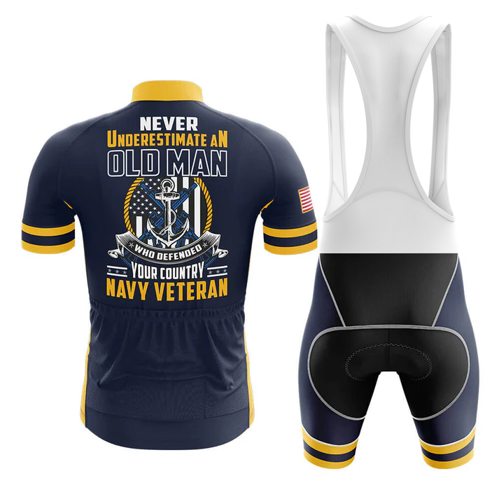 The U.S. Navy V3 Men Short Sleeve Cycling Set features a navy and yellow jersey with “Never underestimate an old man who defended your country, Navy veteran” and anchor, eagle, flag graphic. Includes black and white bib shorts.