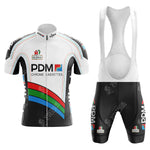 The White Reynolds Retro Short Sleeve Cycling Set includes a jersey and bib shorts featuring a black, white, and colorful stripe design. Bold PDM ULTIMA logos enhance the look. The vintage cycling jersey has a front zipper, while the bib shorts provide mesh back ventilation for comfort.