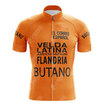 The Gatorade Chateau dAx Retro Short Sleeve Cycling Set features an orange jersey with Butano, Flandria, Velda Latina text, and a front zipper. It includes shorts and displays El Correo Español on the chest. Refer to our size guide for the ideal fit.
