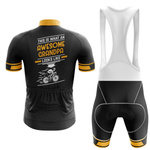 Front and back view of the Scotland Men Short Sleeve Cycling Set in black and yellow. The jersey back says "This is what an awesome grandpa looks like" with a cyclist graphic. Includes moisture-wicking jersey and bib shorts with white straps.