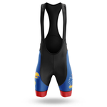 The Ohio State Men Short Sleeve Cycling Set features cycling bib shorts with shoulder straps and a Jayhawk logo on each leg, in blue, red, and black inspired by University of Kansas team colors. Ideal match for any performance cycling jersey. Plain white background.