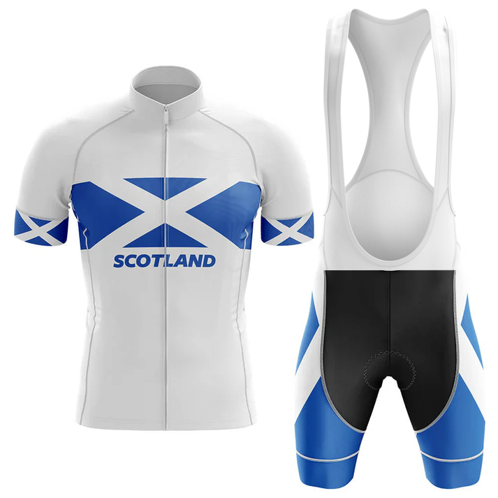 The Specialized V1 Men Short Sleeve Cycling Set features a white and blue design with the Scottish flag and "Scotland" on the jersey. The bib shorts combine blue and black panels, offering performance and style for cyclists.