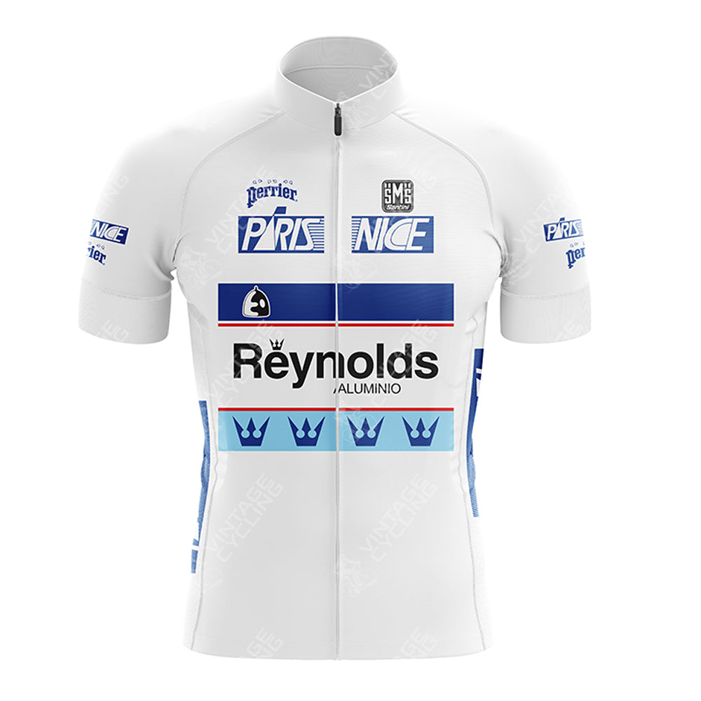 The SCIC Retro Short Sleeve Cycling Set is a white jersey with blue accents, featuring Paris Nice, Reynolds, and Perrier logos. It includes crown motifs on the bottom and chest, a front zipper, and blue side panels.