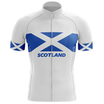 The Specialized V1 Men Short Sleeve Cycling Set features a white jersey with a bold blue and white Scottish flag on chest and sleeves, "SCOTLAND" in blue letters below the flag, paired perfectly with matching men's bib shorts.