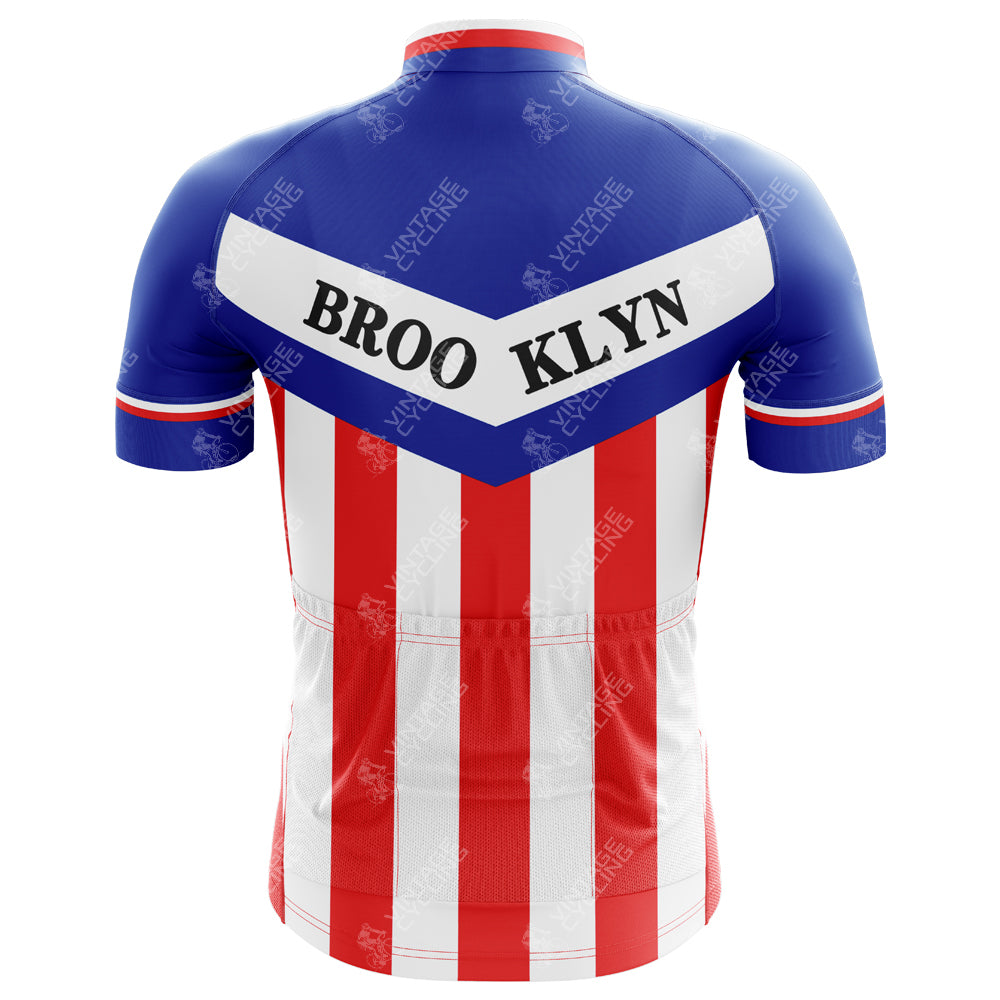 The Brooklyn Chewing Gum Retro Cycling Jersey showcases a bold blue upper with BROOKLYN in black on a white V-shaped band and striking red and white vertical stripes below.