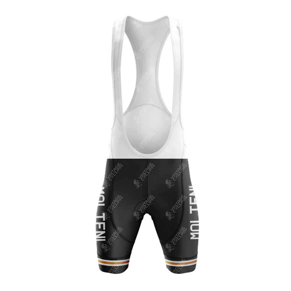Front view of black MOLTENI bib shorts with white straps; MOLTEN printed vertically on each leg. A strip with orange, white, and green accents lines the lower edge, enhancing the retro look of the MOLTENI Black Retro Short Sleeve Cycling Set.