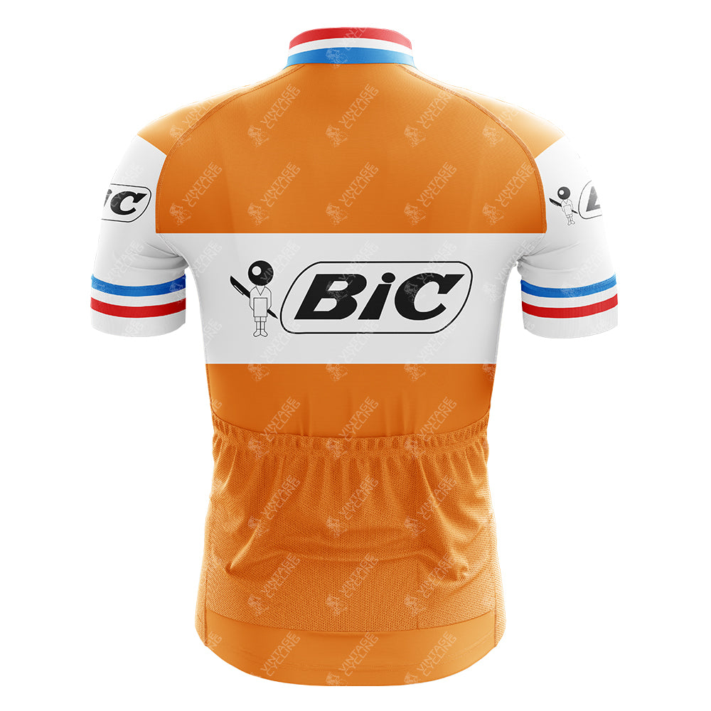 The BIC Orange Retro Short Sleeve Cycling Set features a vintage jersey with the iconic Bic logo, retro short sleeves, blue, white, and red stripes on the cuffs and collar, and three convenient waist pockets.