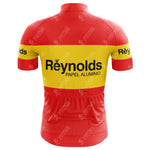The Reynolds-Papel Alumino Retro Cycling Jersey is crafted from lightweight polyester, featuring a red and yellow design with Reynolds-Papel Aluminio text on the back, short sleeves, an elastic waistband with pockets, and small crown motifs for a classic look.