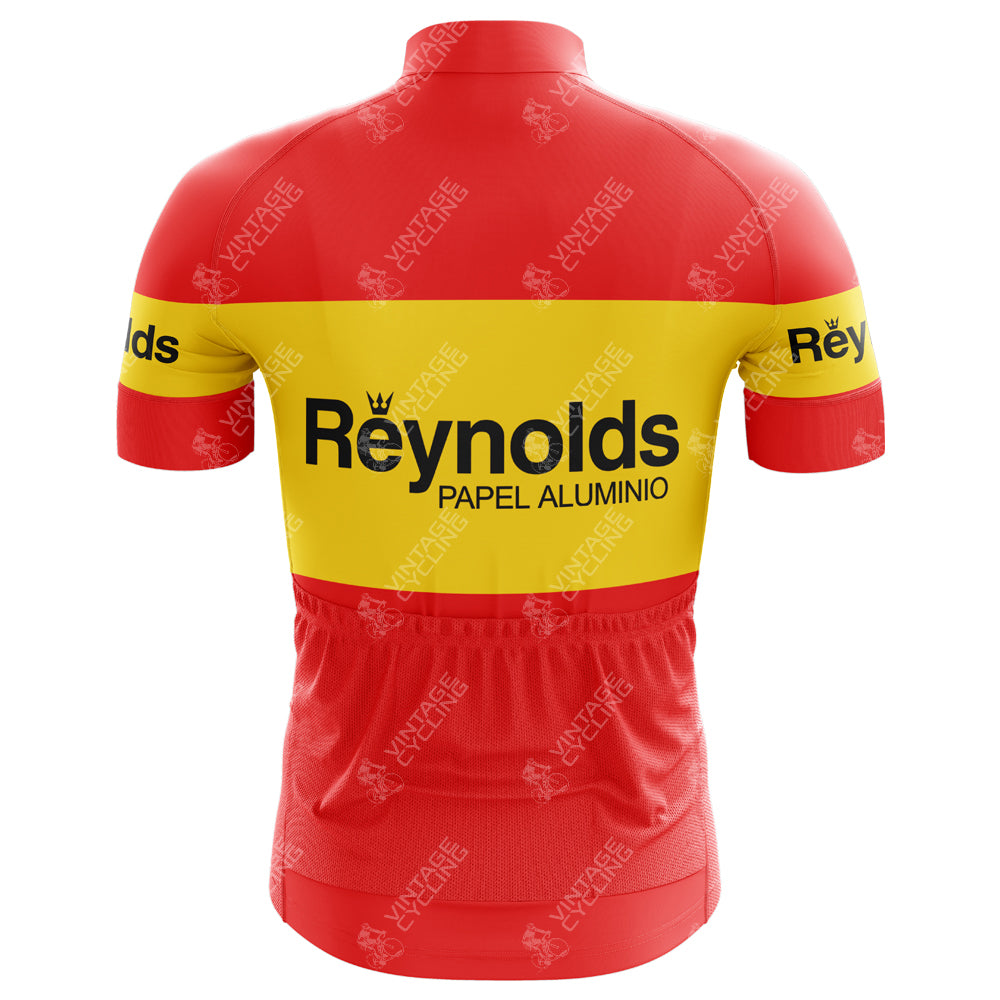 The Reynolds-Papel Alumino Retro Cycling Jersey is crafted from lightweight polyester, featuring a red and yellow design with Reynolds-Papel Aluminio text on the back, short sleeves, an elastic waistband with pockets, and small crown motifs for a classic look.