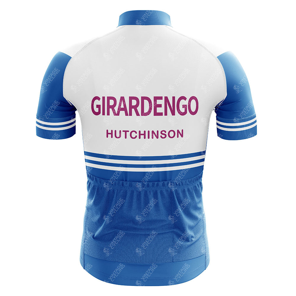 The Marc Superia Retro Cycling Jersey, shown from the back, features blue sleeves and horizontal white stripes. Made from lightweight polyester, it displays MARC SUPERIA in large pink letters with HUTCHINSON in smaller pink letters below.