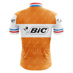 The BIC Orange Retro Short Sleeve Cycling Set features a vintage jersey with the iconic Bic logo, retro short sleeves, blue, white, and red stripes on the cuffs and collar, and three convenient waist pockets.