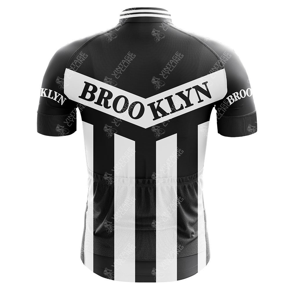 A retro cycling jersey inspired by Brooklyn Chewing Gum and Roger de Vlaeminck, featuring black and white stripes with BROOKLYN on a diagonal white band across the upper back and on the sleeves.