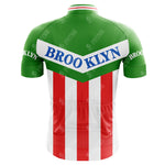 The Brooklyn Chewing Gum Retro Cycling Jerseys back showcases green shoulders, a white top with BROOKLYN in blue, red and white vertical stripes at the bottom, and sleeves featuring the iconic BROOKLYN motif, inspired by Roger de Vlaemincks era.