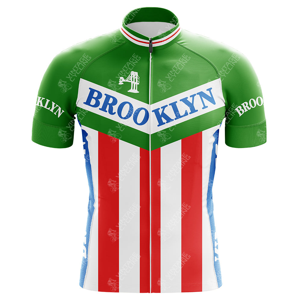 The Brooklyn Chewing Gum Retro Cycling Jersey showcases a classic blue diagonal Brooklyn logo with green sleeves, red vertical stripes, and a tribute to Roger de Vlaeminck with a small Brooklyn Bridge graphic on the white chest panel.