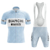 The Bianchi Blue Retro Short Sleeve Cycling Set features a light blue and white kit with BIANCHI and PIRELLI logos in bold black. The set includes a short-sleeved jersey with a front zipper and matching bib shorts.