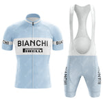 The Bianchi Blue Retro Short Sleeve Cycling Set features a light blue and white kit with BIANCHI and PIRELLI logos in bold black. The set includes a short-sleeved jersey with a front zipper and matching bib shorts.