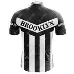 A retro cycling jersey inspired by Brooklyn Chewing Gum and Roger de Vlaeminck, featuring black and white stripes with BROOKLYN on a diagonal white band across the upper back and on the sleeves.