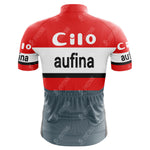 The Cilo-Aufina Retro Cycling Jersey showcases a classic red and white design with bold Cilo and aufina lettering, inspired by the Tour de Suisse style. It features black, red, and white stripes and is made from lightweight polyester for maximum comfort.