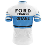The Ford France Gitane Retro Cycling Jersey features a blue and white design with Ford France Gitane text, blue sleeve stripes, and a black band above the back pocket. Its crafted from lightweight polyester for comfort and performance.